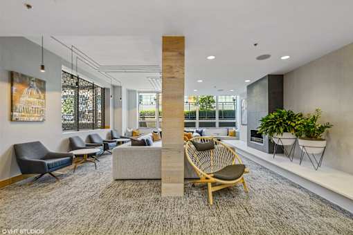 A modern office space with a large wooden column and comfortable seating.