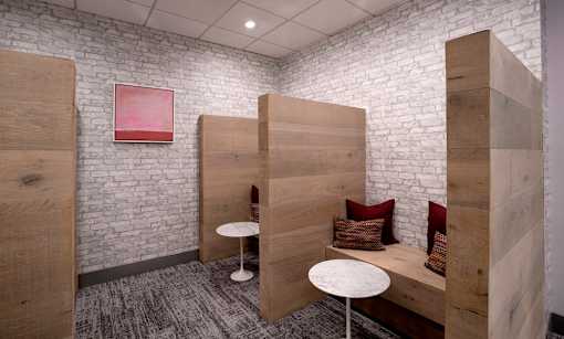 A room with a white brick wall and wooden boards on the wall.