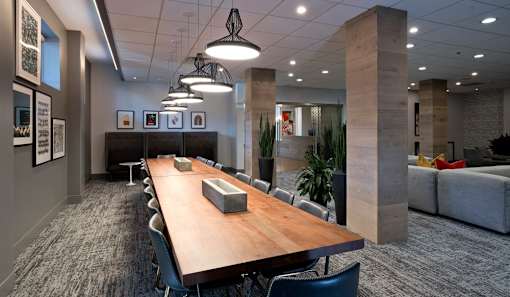 A conference room with a long table and chairs.