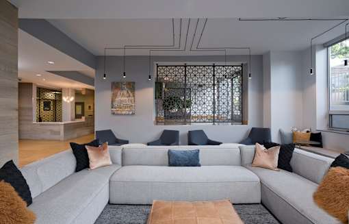 A modern living room with a grey sofa and a wooden coffee table.