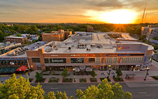 A sunset view of a large building with the word "Giant" on it.