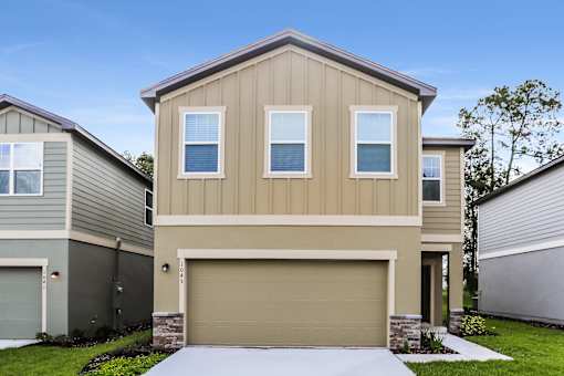 A modern house with a garage door in the front.