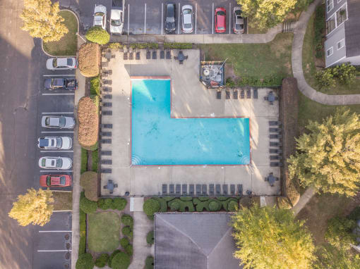 Twin Oaks Apartments in Hattiesburg Mississippi photo of arial view of a swimming pool in a yard with cars parked in the parking lot