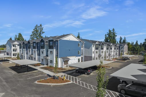 an aerial view of a row of apartment buildings in a parking lot,