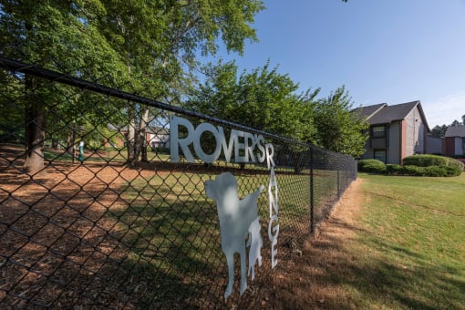 Lawrenceville, GA Apartments – Park on Sweetwater – a sign on a fence in front of a dog park