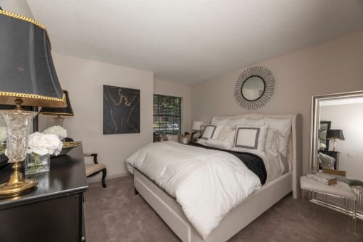 Dog-Friendly Apartments In Lawrenceville - Park On Sweetwater Apartments - Spacious Bedroom With Plush Carpeting And A Window For Natural Sunlight