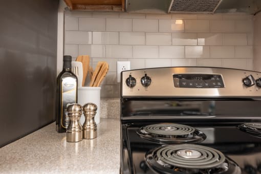 Apartments in Lawrenceville Georgia for Rent – Park on Sweetwater - a kitchen with a stove and a bottle of wine on the counter