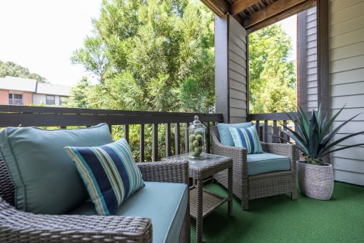 Lawrenceville, GA Apartments – Park on Sweetwater – a covered porch with wicker furniture and a window