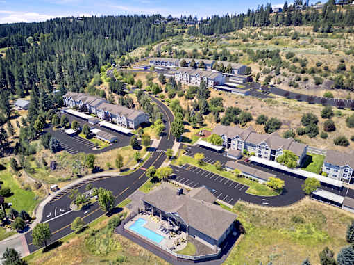 A bird's eye view of a residential area with a swimming pool.