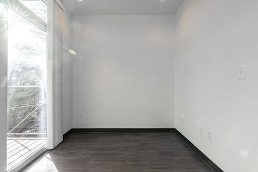 A room with a wooden floor and white walls.