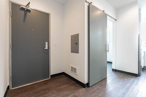 A room with a grey door and a white door.