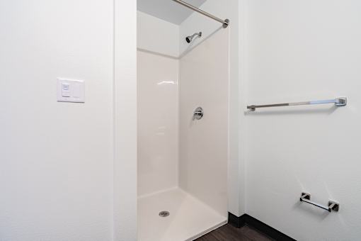 A white bathroom with a walk in shower.