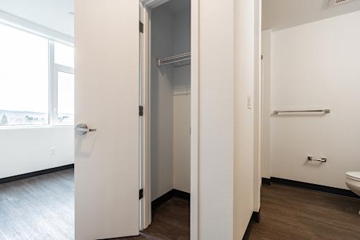 A white door is open to a small bathroom.