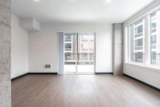 A large empty room with a sliding glass door.