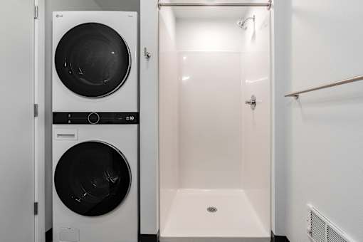 A white laundry room with a washer and dryer.
