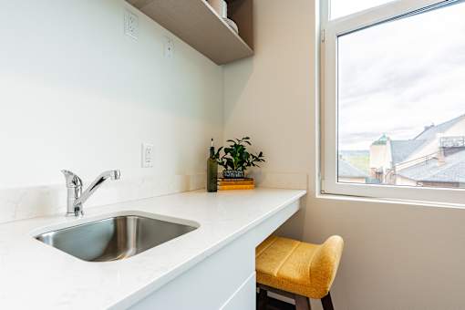 A kitchen with a sink and a window.