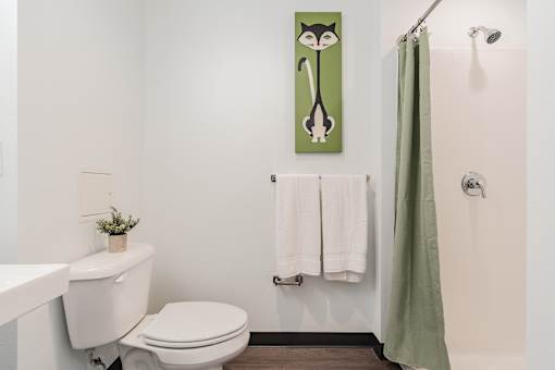A white toilet sits next to a white sink in a bathroom.