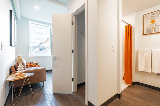 A bathroom with a towel rack and a painting on the wall.