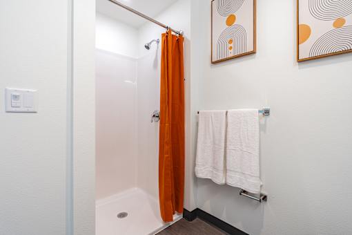A bathroom with a white towel hanging on a rack.