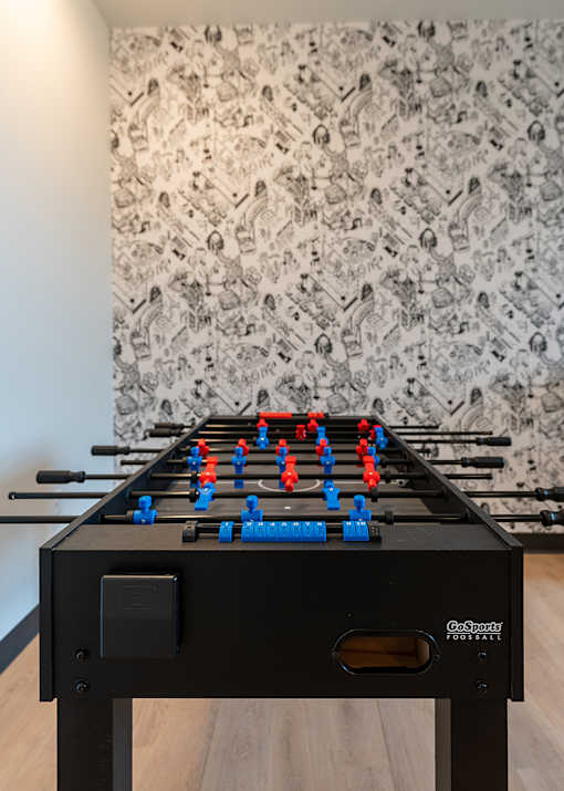 A black GoSticky foosball table with red and blue players.