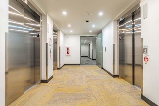 A long hallway with elevators on both sides.
