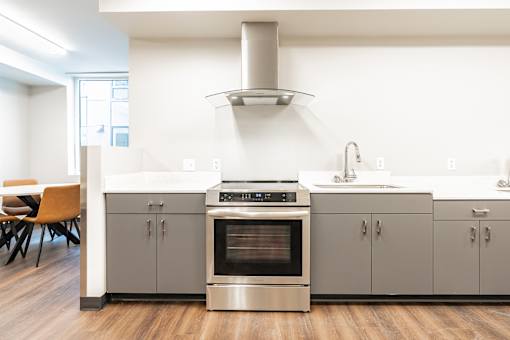 A modern kitchen with a stainless steel oven and cabinets.