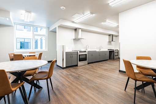 A modern kitchen with a dining table and chairs.