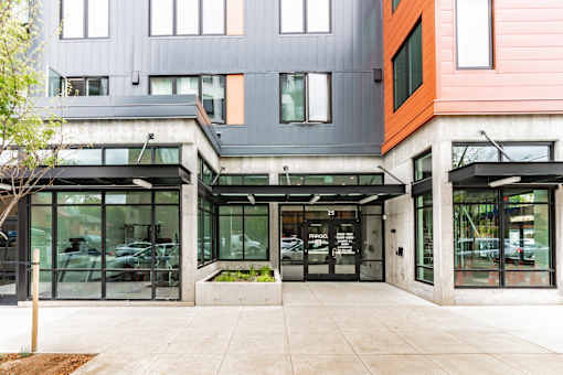 A modern building with a grey and orange facade.