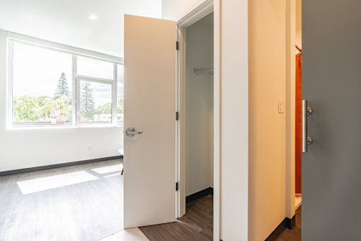 A white door is open to a hallway.