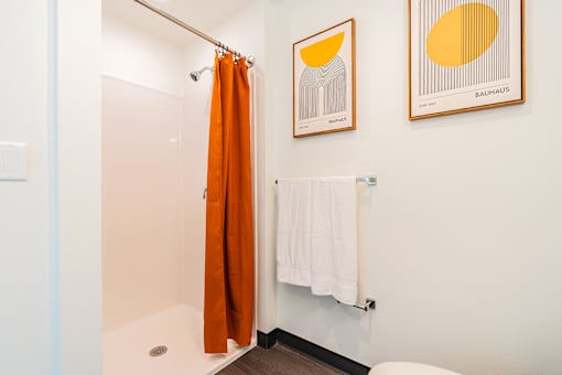 A bathroom with a white towel hanging on the wall.