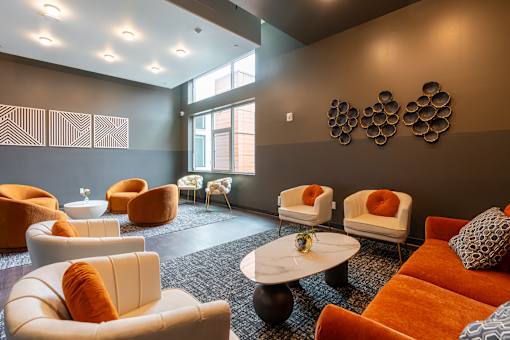 A living room with orange and white furniture.