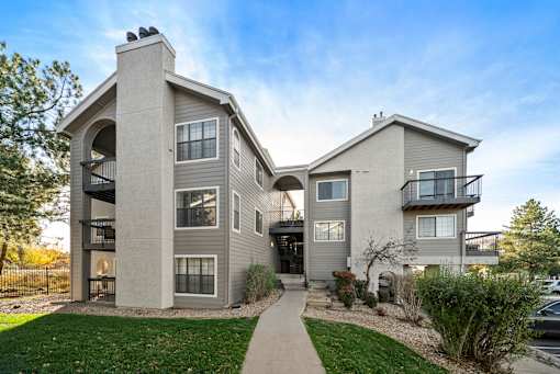 A modern two-story house with a balcony on the second floor.