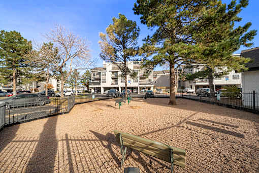 A park with a bench and a playground.
