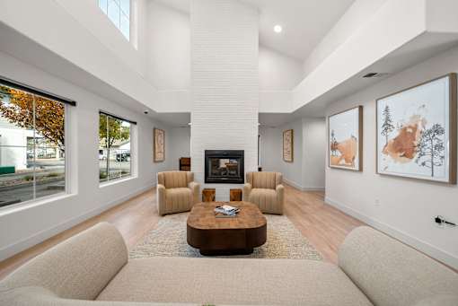 A living room with a fireplace and a painting on the wall.