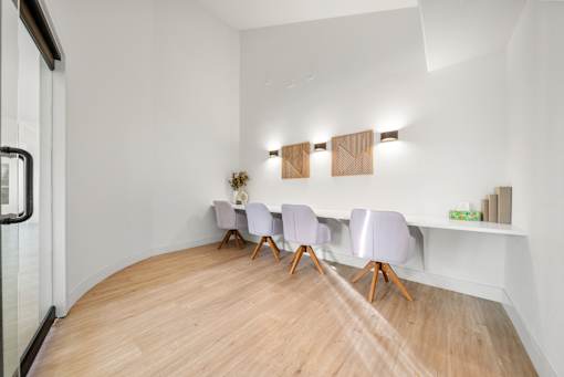 A conference room with a long table and chairs.