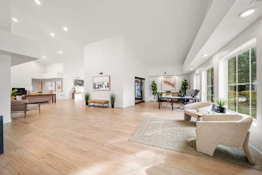 A spacious living room with a large window and a couch.