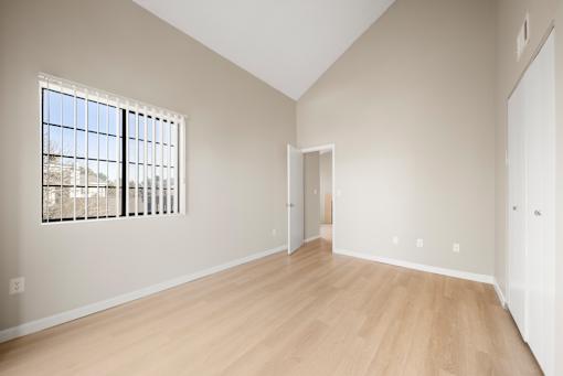 Empty room with wooden floor and a window.