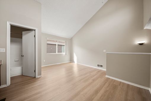 A room with a white door and a window.