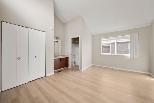 A room with a white door and a window with blinds.
