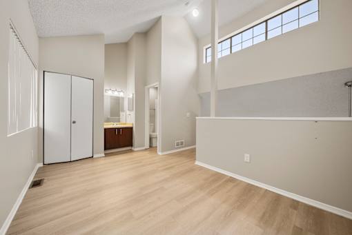 A large empty room with wooden floors and white walls.