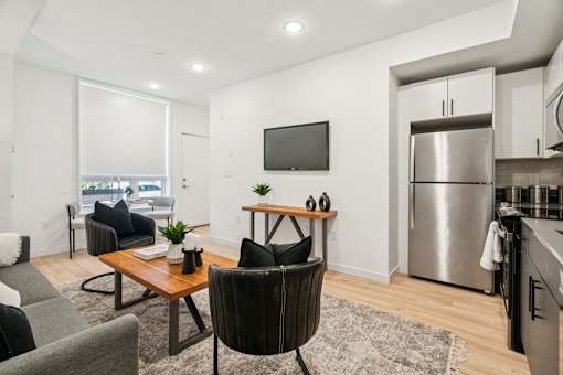 A modern kitchen with a dining table and chairs.