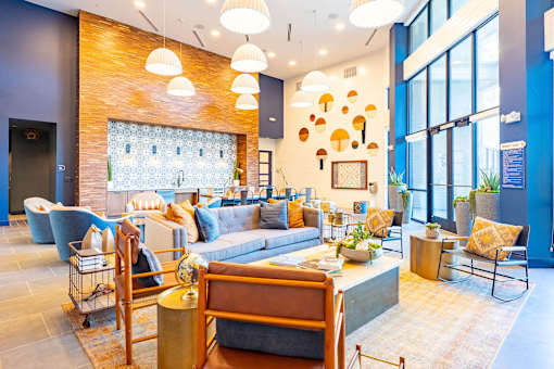 A modern living room with a brick wall and a large window.
