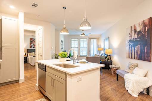 A kitchen with a white counter top and a large island.