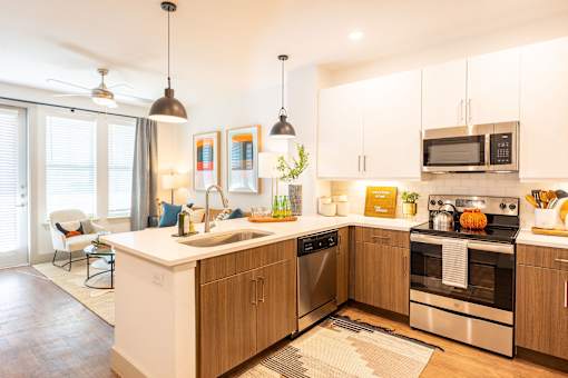 A modern kitchen with wooden cabinets and stainless steel appliances.