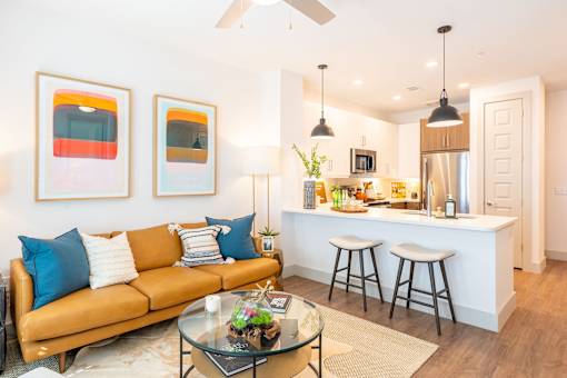 A living room with a couch, a coffee table, and a bar area.
