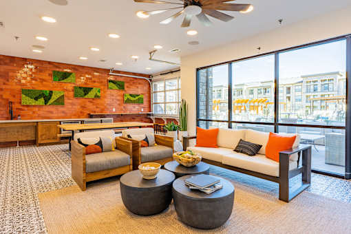 A living room with a couch, two chairs, and a coffee table.