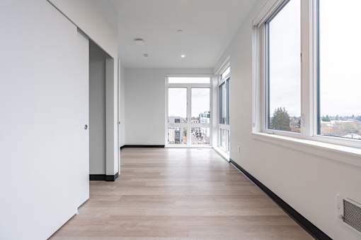 A long hallway with a lot of windows on the right side.