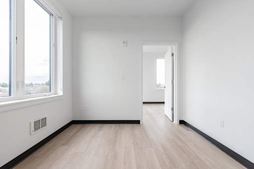 A room with white walls and a wooden floor.