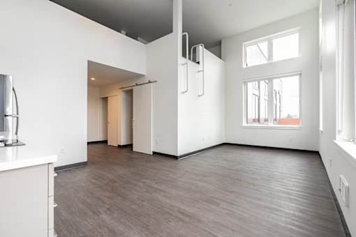 A spacious room with a white cabinet and a grey ceiling.