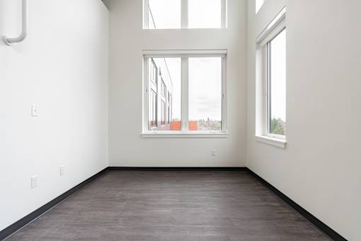 Empty room with a window and a door.